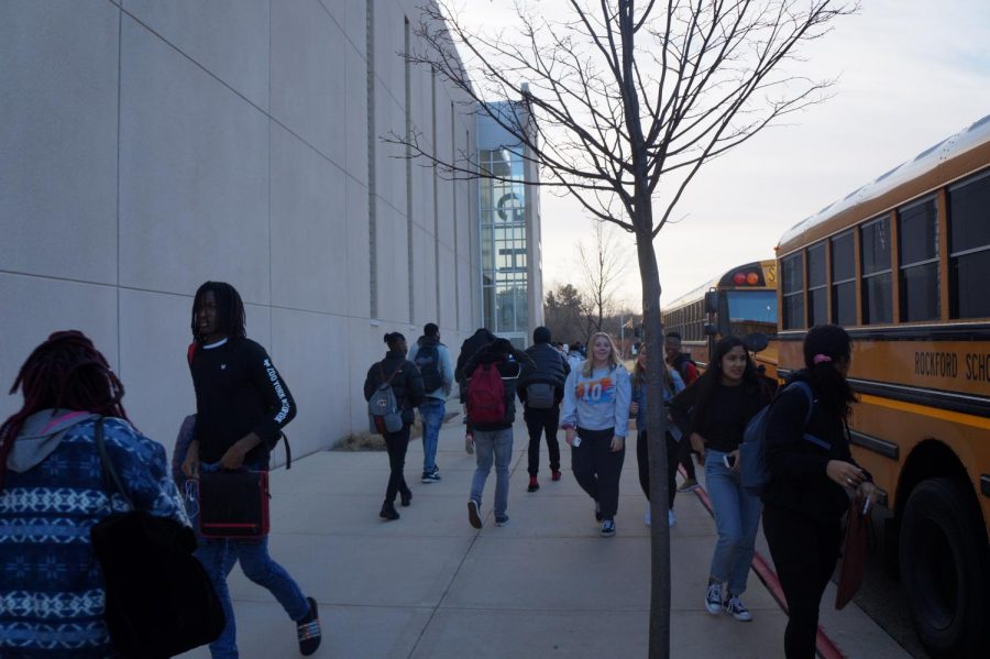 Students make their way from the new bus drop-off to the main entrance.