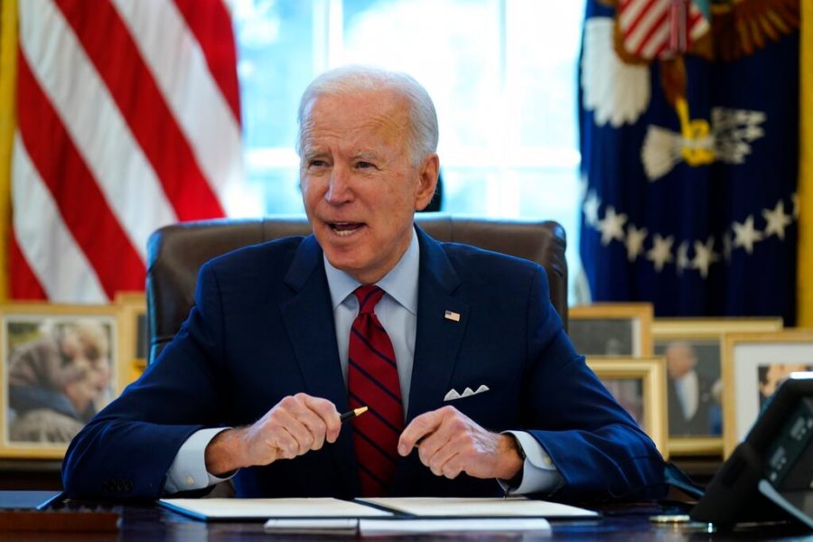 President Joe Biden signs a series of executive orders on health care, in the Oval Office of the White House, Thursday, Jan. 28, 2021, in Washington. (AP Photo/Evan Vucci)