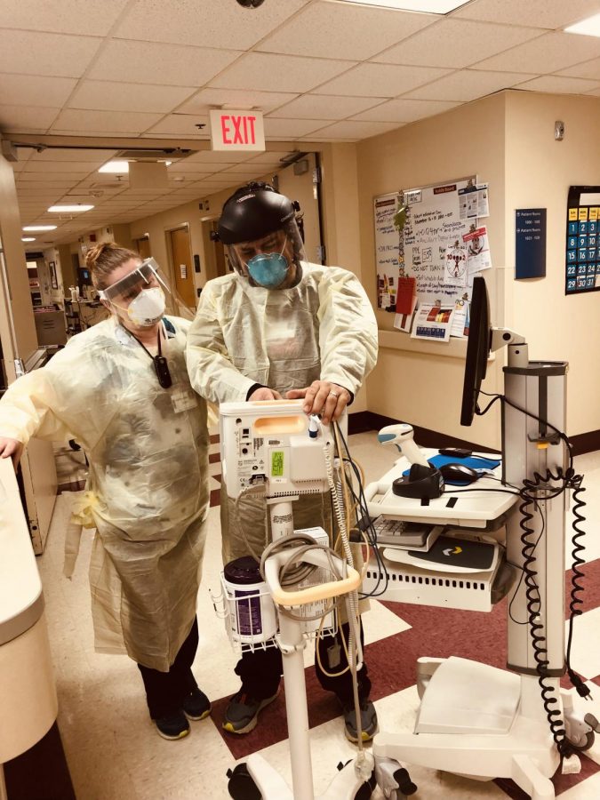 Erika Spence and John Piterson examine a medical device on the Special Precautions floor at Swedish American Hospital.