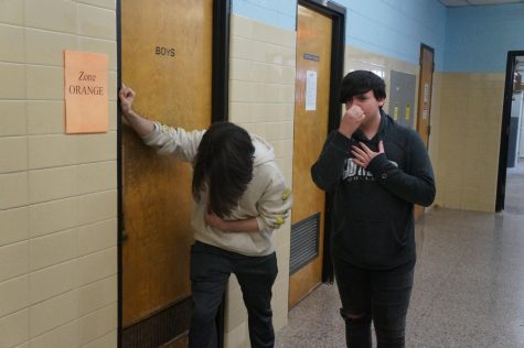 Students gag in distress outside of a foul smelling bathroom. (photo illustration)