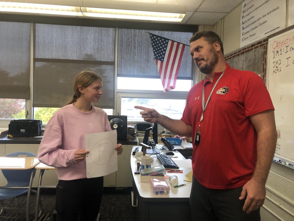 Larkin Blanekey, sophomore gets tips on improving her summative grade from Mr. Appino. (Photo Illustration)
