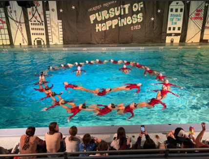 The 2022-2023 Valks team make a smiley face in the water during the show.