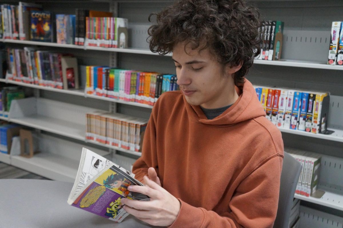 Bryson Halley, sophomore, inspecting a book